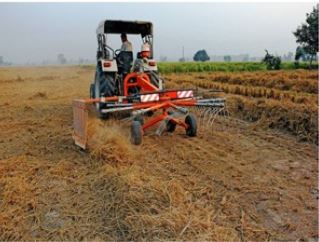 Piling of Stubble with Rake.JPG